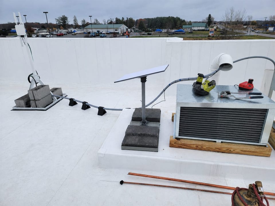 Rooftop Starlink installation with cable routing and service equipment.